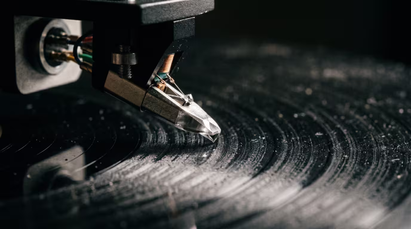 Macro view of a turntable stylus and cantilever above a record groove