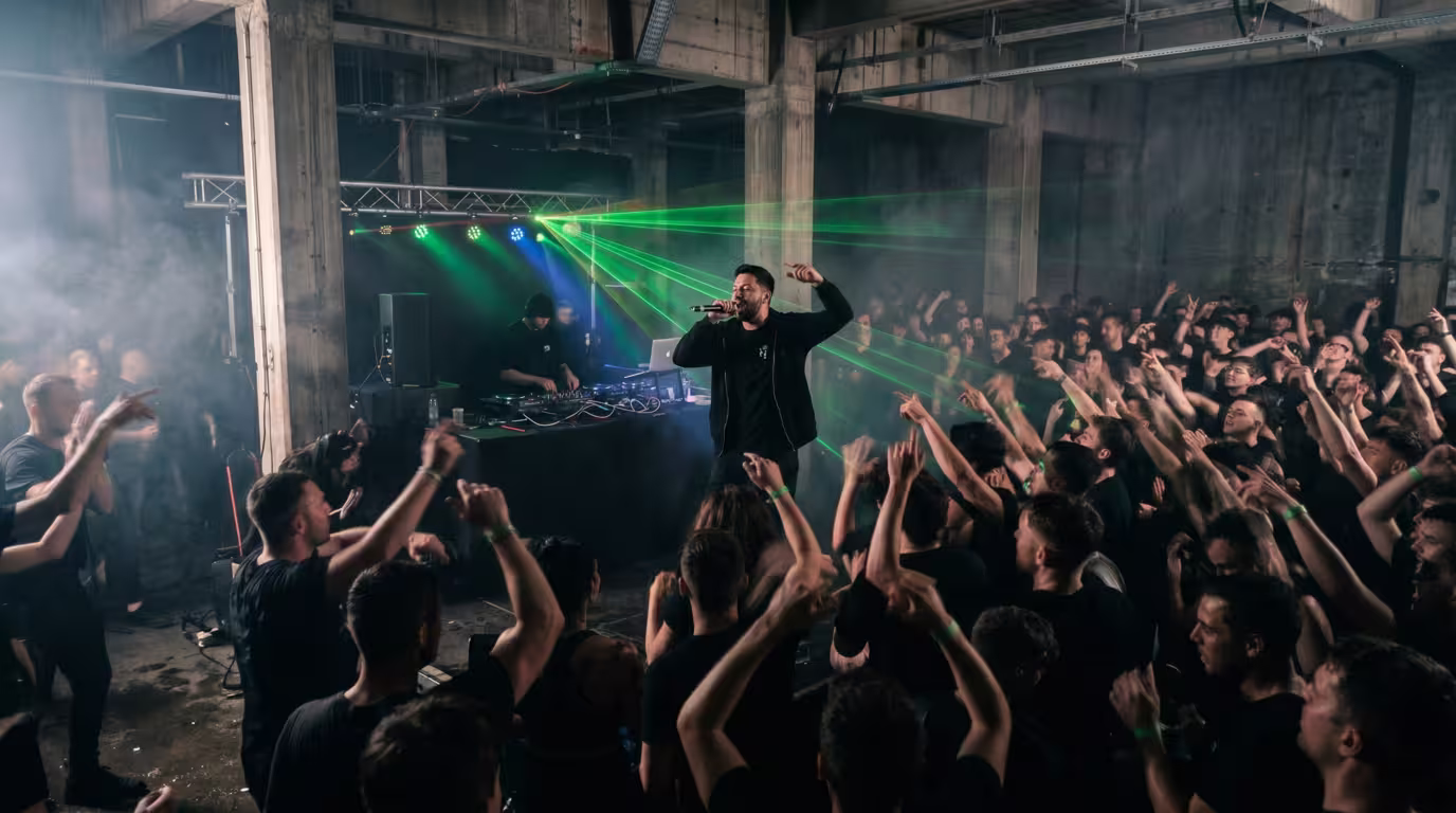 MC and crowd at a dark drum and bass rave with lasers and haze