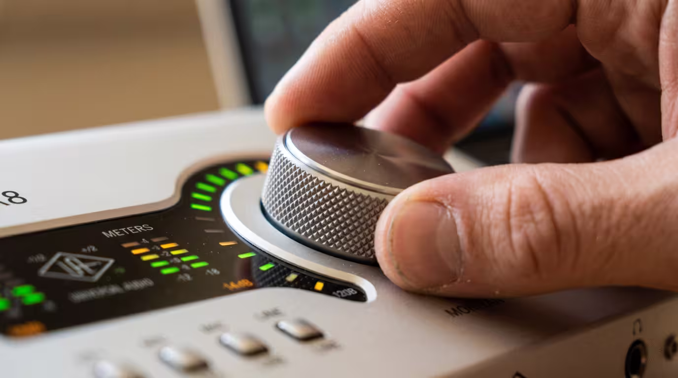 An audio interface on a bright studio desk where sample rate and bit depth are set