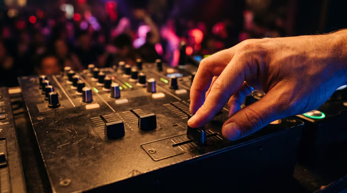 A hand on the crossfader of a two-channel battle mixer