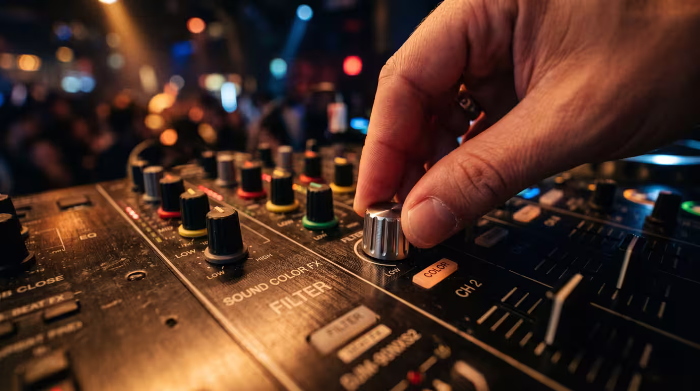A hand turning the filter knob on a Pioneer DJM mixer channel